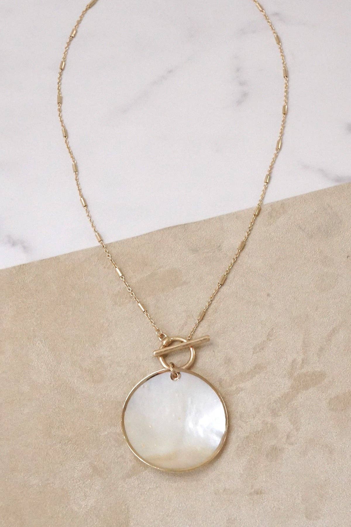 Minimalist boho short gold necklace with golden framed round shell