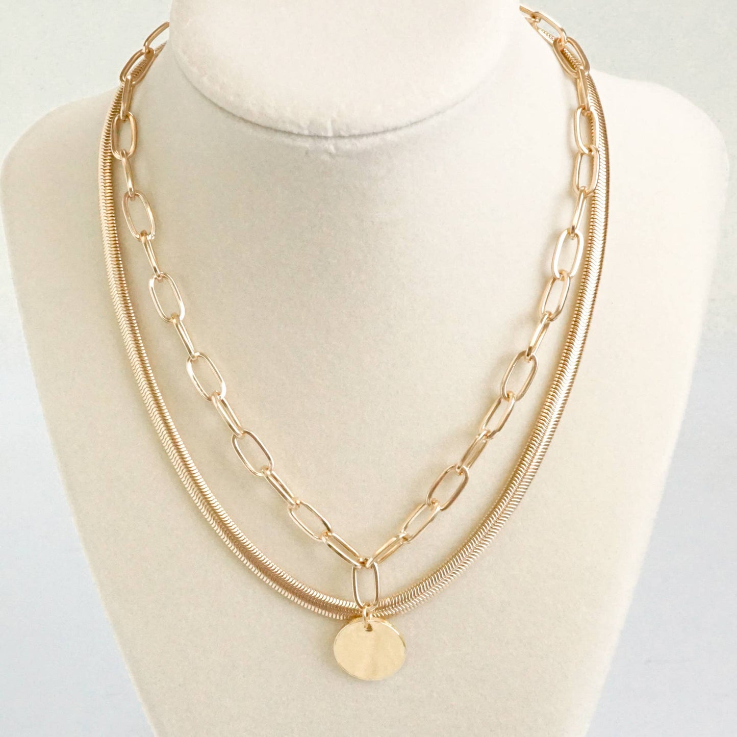 Layered gold tone short necklace set with a coin pendant